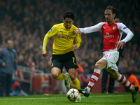 Shinji Kagawa of Borussia Dortmund is closely followed by Nacho Monreal of Arsenal during the UEFA Champions League Group D soccer match bet...