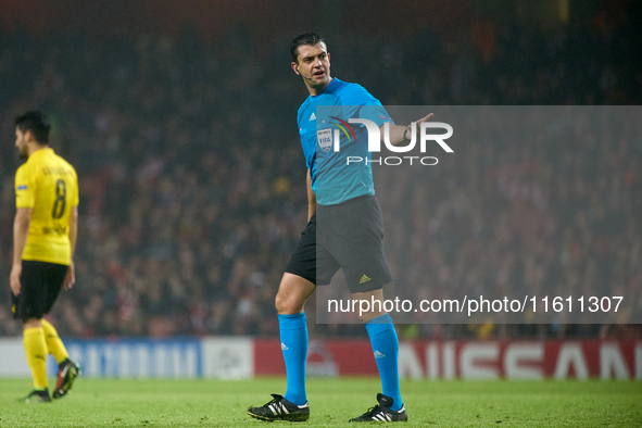 UEFA appoints match referee Viktor Kassai, who gestures during the UEFA Champions League Group D soccer match between Arsenal and Borussia D...