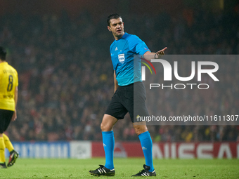 UEFA appoints match referee Viktor Kassai, who gestures during the UEFA Champions League Group D soccer match between Arsenal and Borussia D...