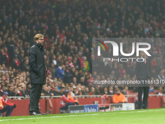 Jurgen Klopp (L), head coach of Borussia Dortmund, and Arsene Wenger (R), head coach of Arsenal, during the UEFA Champions League Group D so...