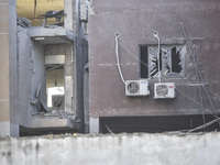 People and rescuers gather at the site of an Israeli airstrike that targets an apartment on al-Qaem Street in Beirut's southern suburbs on S...