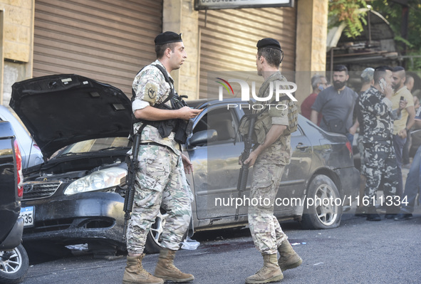 Lebanese forces secure the area and take precautionary measures following an Israeli army drone strike that targets a vehicle on the Kahale-...