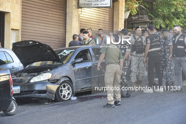 Lebanese forces secure the area and take precautionary measures following an Israeli army drone strike that targets a vehicle on the Kahale-...