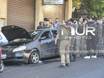 Lebanese forces secure the area and take precautionary measures following an Israeli army drone strike that targets a vehicle on the Kahale-...