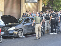 Lebanese forces secure the area and take precautionary measures following an Israeli army drone strike that targets a vehicle on the Kahale-...