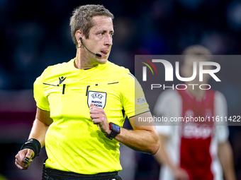 Referee John Brooks officiates the match between Ajax and Besiktas at the Johan Cruijff ArenA for the UEFA Europa League - League phase - Ma...