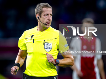 Referee John Brooks officiates the match between Ajax and Besiktas at the Johan Cruijff ArenA for the UEFA Europa League - League phase - Ma...