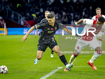 Besiktas JK midfielder Milot Rashica and AFC Ajax Amsterdam defender Jorrel Hato during the match between Ajax and Besiktas at the Johan Cru...