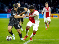 Besiktas JK midfielder Milot Rashica and AFC Ajax Amsterdam defender Jorrel Hato during the match between Ajax and Besiktas at the Johan Cru...