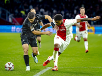 Besiktas JK midfielder Milot Rashica and AFC Ajax Amsterdam defender Jorrel Hato during the match between Ajax and Besiktas at the Johan Cru...