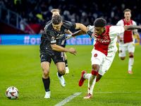 Besiktas JK midfielder Milot Rashica and AFC Ajax Amsterdam defender Jorrel Hato during the match between Ajax and Besiktas at the Johan Cru...