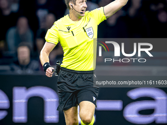 Referee John Brooks officiates the match between Ajax and Besiktas at the Johan Cruijff ArenA for the UEFA Europa League - League phase - Ma...