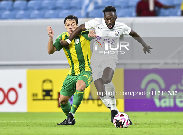 Lucas Mendes (L) of Al Wakrah SC battles for the ball with Yohan Boli (R) of Al-Khor SC during the Ooredoo Qatar Stars League 24/25 match be...