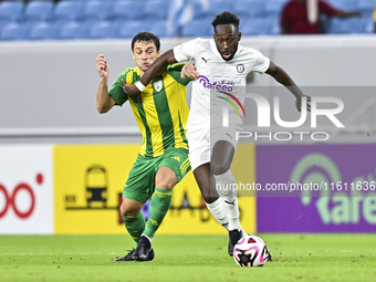 Lucas Mendes (L) of Al Wakrah SC battles for the ball with Yohan Boli (R) of Al-Khor SC during the Ooredoo Qatar Stars League 24/25 match be...