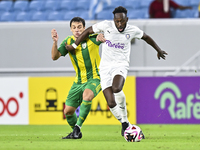 Lucas Mendes (L) of Al Wakrah SC battles for the ball with Yohan Boli (R) of Al-Khor SC during the Ooredoo Qatar Stars League 24/25 match be...