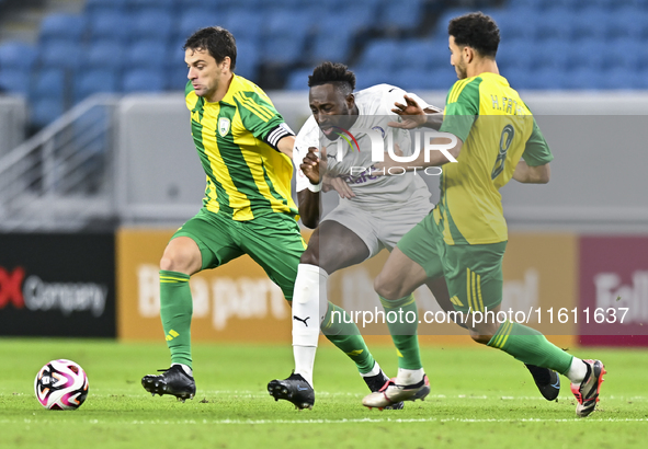 Lucas Mendes (L) of Al Wakrah SC battles for the ball with Yohan Boli (C) of Al-Khor SC during the Ooredoo Qatar Stars League 24/25 match be...