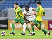 Lucas Mendes (L) of Al Wakrah SC battles for the ball with Yohan Boli (C) of Al-Khor SC during the Ooredoo Qatar Stars League 24/25 match be...