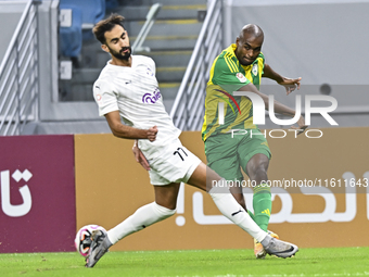 Abdelkarim Hassan (R) of Al Wakrah SC battles for the ball with Abdulrahman Rashed Juma (L) of Al-Khor SC during the Ooredoo Qatar Stars Lea...