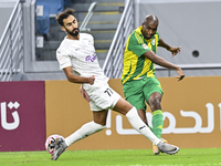 Abdelkarim Hassan (R) of Al Wakrah SC battles for the ball with Abdulrahman Rashed Juma (L) of Al-Khor SC during the Ooredoo Qatar Stars Lea...