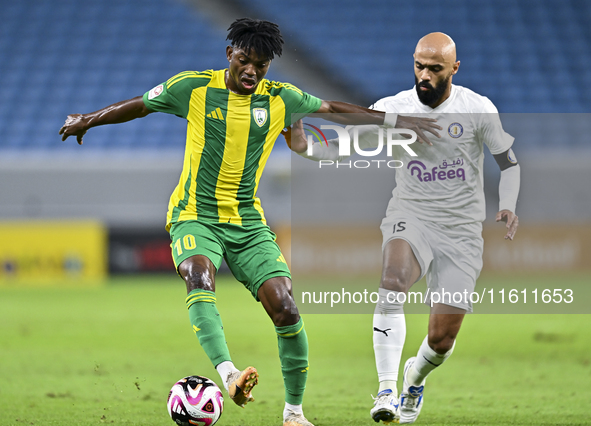 Jacinto Dala (L) of Al Wakrah SC battles for the ball with Gaser Naif Mubarak Al-Buriki (R) of Al-Khor SC during the Ooredoo Qatar Stars Lea...