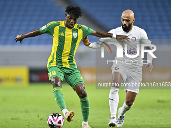 Jacinto Dala (L) of Al Wakrah SC battles for the ball with Gaser Naif Mubarak Al-Buriki (R) of Al-Khor SC during the Ooredoo Qatar Stars Lea...