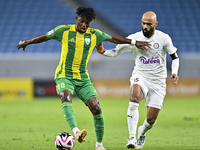 Jacinto Dala (L) of Al Wakrah SC battles for the ball with Gaser Naif Mubarak Al-Buriki (R) of Al-Khor SC during the Ooredoo Qatar Stars Lea...