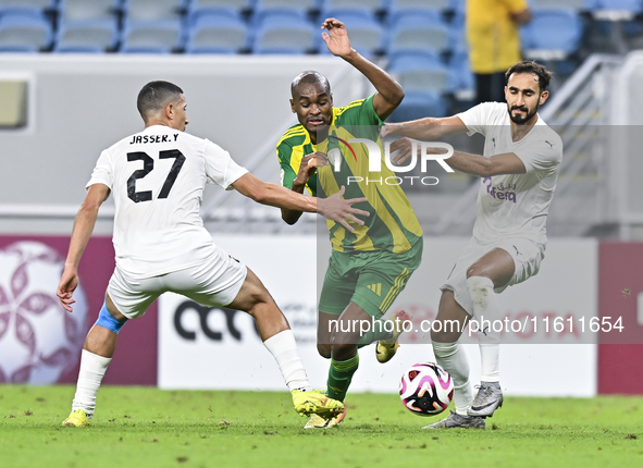 Abdelkarim Hassan (C) of Al Wakrah SC battles for the ball with Gaser Yahia Madani (L) of Al-Khor SC during the Ooredoo Qatar Stars League 2...