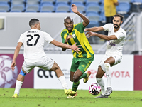 Abdelkarim Hassan (C) of Al Wakrah SC battles for the ball with Gaser Yahia Madani (L) of Al-Khor SC during the Ooredoo Qatar Stars League 2...