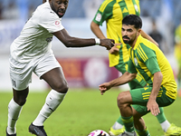 Omar Salah Alosad (#6) of Al Wakrah SC battles for the ball with Yohan Boli (L) of Al-Khor SC during the Ooredoo Qatar Stars League 24/25 ma...