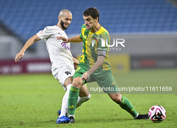 Lucas Mendes (#2) of Al Wakrah SC battles for the ball with Sofiane Hanni (L) of Al-Khor SC during the Ooredoo Qatar Stars League 24/25 matc...