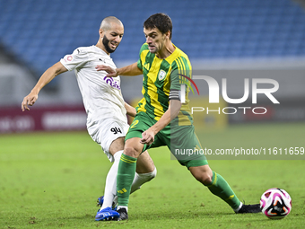 Lucas Mendes (#2) of Al Wakrah SC battles for the ball with Sofiane Hanni (L) of Al-Khor SC during the Ooredoo Qatar Stars League 24/25 matc...