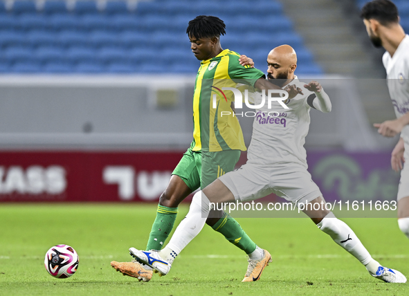 Jacinto Dala (L) of Al Wakrah SC battles for the ball with Naif Mubarak Al-Buriki (R) of Al-Khor SC during the Ooredoo Qatar Stars League 24...