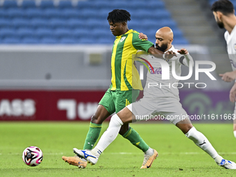 Jacinto Dala (L) of Al Wakrah SC battles for the ball with Naif Mubarak Al-Buriki (R) of Al-Khor SC during the Ooredoo Qatar Stars League 24...