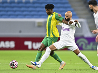 Jacinto Dala (L) of Al Wakrah SC battles for the ball with Naif Mubarak Al-Buriki (R) of Al-Khor SC during the Ooredoo Qatar Stars League 24...