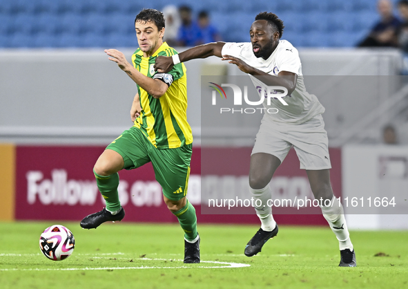 Lucas Mendes (L) of Al Wakrah SC battles for the ball with Yohan Boli (R) of Al-Khor SC during the Ooredoo Qatar Stars League 24/25 match be...