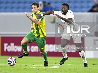 Lucas Mendes (L) of Al Wakrah SC battles for the ball with Yohan Boli (R) of Al-Khor SC during the Ooredoo Qatar Stars League 24/25 match be...