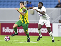 Lucas Mendes (L) of Al Wakrah SC battles for the ball with Yohan Boli (R) of Al-Khor SC during the Ooredoo Qatar Stars League 24/25 match be...