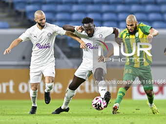 Aissa Belal Laidouni (L) of Al Wakrah SC battles for the ball with Yohan Boli (C) of Al-Khor SC during the Ooredoo Qatar Stars League 24/25...