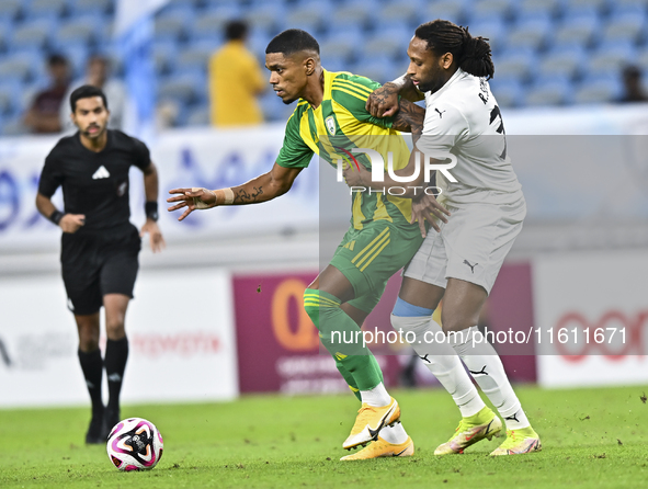 Ricardo Gomes (L) of Al Wakrah SC battles for the ball with Yohan Boli (R) of Al-Khor SC during the Ooredoo Qatar Stars League 24/25 match b...