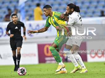 Ricardo Gomes (L) of Al Wakrah SC battles for the ball with Yohan Boli (R) of Al-Khor SC during the Ooredoo Qatar Stars League 24/25 match b...