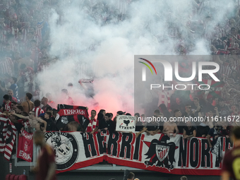 Athletic fans throw flares at Roma fans during the UEFA Europa League 2024/25 League Phase MD1 match between AS Roma and Athletic Club at St...