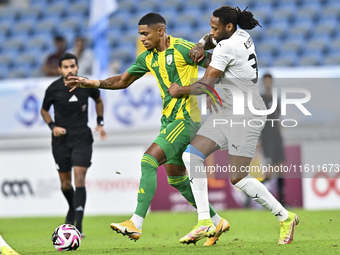 Ricardo Gomes (L) of Al Wakrah SC battles for the ball with Yohan Boli (R) of Al-Khor SC during the Ooredoo Qatar Stars League 24/25 match b...