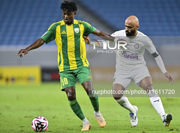 Jacinto Dala (#10) of Al Wakrah SC battles for the ball with Naif Mubarak Al-Buriki (R) of Al-Khor SC during the Ooredoo Qatar Stars League...