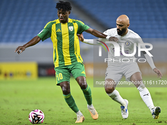 Jacinto Dala (#10) of Al Wakrah SC battles for the ball with Naif Mubarak Al-Buriki (R) of Al-Khor SC during the Ooredoo Qatar Stars League...