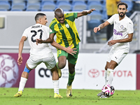 Abdelkarim Hassan (C) of Al Wakrah SC battles for the ball with Gaser Yahia Madani (L) of Al-Khor SC during the Ooredoo Qatar Stars League 2...