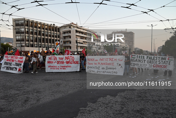 Demonstrators hold banners and flags outside the Israeli Embassy protesting against the Israeli strikes in Lebanon and the ongoing war in Ga...