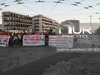 Demonstrators hold banners and flags outside the Israeli Embassy protesting against the Israeli strikes in Lebanon and the ongoing war in Ga...