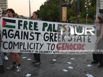 Demonstrators hold a banner outside the Israeli Embassy protesting against the Israeli strikes in Lebanon and the ongoing war in Gaza in Ath...