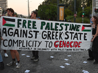 Demonstrators hold a banner outside the Israeli Embassy protesting against the Israeli strikes in Lebanon and the ongoing war in Gaza in Ath...