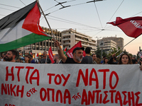 Demonstrators hold a banner and wave flags outside the Israeli Embassy protesting against the Israeli strikes in Lebanon and the ongoing war...